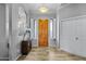 Bright and airy foyer with wood flooring and a wooden door at 1040 N 113Th Pl, Mesa, AZ 85207