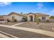Single-story home with a landscaped yard and walkway at 1040 N 113Th Pl, Mesa, AZ 85207