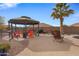 Relaxing gazebo with colorful seating and a fire pit area at 1040 N 113Th Pl, Mesa, AZ 85207