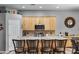 Island kitchen with light wood cabinets and granite countertops at 1040 N 113Th Pl, Mesa, AZ 85207