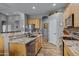 Modern kitchen featuring granite countertops, stainless steel appliances, and wood cabinets at 1040 N 113Th Pl, Mesa, AZ 85207