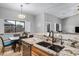 Kitchen features a large granite island with sink and breakfast bar seating at 1040 N 113Th Pl, Mesa, AZ 85207