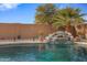 Beautiful pool with a waterfall feature and colorful pots at 1040 N 113Th Pl, Mesa, AZ 85207