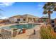Inviting backyard oasis with a sparkling pool, gazebo, and lush landscaping at 1040 N 113Th Pl, Mesa, AZ 85207