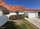 Front view of a Spanish style home with a white exterior and terracotta roof at 10602 W Deanne Dr, Sun City, AZ 85351