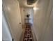 Simple hallway with carpet runner and light walls at 10602 W Deanne Dr, Sun City, AZ 85351