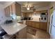 Kitchen with light wood cabinets and a convenient island at 10602 W Deanne Dr, Sun City, AZ 85351