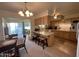 Eat-in kitchen with light wood cabinets, island with seating, and access to backyard at 10602 W Deanne Dr, Sun City, AZ 85351
