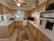 Bright kitchen featuring light wood cabinets and ample counter space at 10602 W Deanne Dr, Sun City, AZ 85351