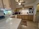Kitchen with light wood cabinets, and a view of the adjacent dining area at 10602 W Deanne Dr, Sun City, AZ 85351