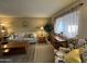 Bright living room features comfy seating and large window at 10602 W Deanne Dr, Sun City, AZ 85351