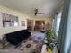 Sunroom features a comfortable couch and access to backyard at 10602 W Deanne Dr, Sun City, AZ 85351