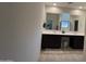 Double vanity bathroom with dark brown cabinets and tile floors at 10961 W Taylor St, Avondale, AZ 85323