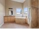 Bathroom with corner bathtub, double sinks, and large windows at 11293 N Thunder Mountain Rd, Coolidge, AZ 85128