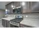 Modern kitchen features stainless steel appliances and gray cabinetry at 13141 W Crestvale Dr, Peoria, AZ 85383