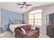 Bedroom with a queen bed, ceiling fan and large window at 13450 W Maui Ln, Surprise, AZ 85379