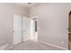 Bright bedroom with double door closet and carpet flooring at 13450 W Maui Ln, Surprise, AZ 85379