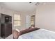 Spacious bedroom with a couch and large TV at 13450 W Maui Ln, Surprise, AZ 85379