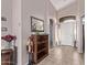 Bright and airy entryway with tile flooring and a wooden bookshelf at 13450 W Maui Ln, Surprise, AZ 85379