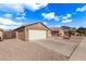 House exterior showcasing a two-car garage and gravel driveway at 13450 W Maui Ln, Surprise, AZ 85379