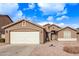 One-story home with a two-car garage and desert landscaping at 13450 W Maui Ln, Surprise, AZ 85379