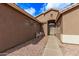 Front entry with a walkway and decorative wrought iron door at 13450 W Maui Ln, Surprise, AZ 85379