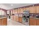 Well-equipped kitchen featuring wood cabinets and granite countertops at 13450 W Maui Ln, Surprise, AZ 85379
