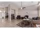 Living room with tile floors, neutral walls, and a cozy seating area at 13450 W Maui Ln, Surprise, AZ 85379