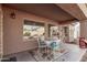Covered patio with seating area and small table at 13450 W Maui Ln, Surprise, AZ 85379