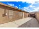 Side yard with concrete patio and storage area at 13450 W Maui Ln, Surprise, AZ 85379