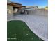 Backyard with paved patio and artificial turf at 13622 W Peck Ct, Litchfield Park, AZ 85340