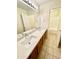Double vanity bathroom with a quartz countertop and tile floor at 13622 W Peck Ct, Litchfield Park, AZ 85340