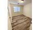 Bedroom with wood-look vinyl flooring and window blinds at 13622 W Peck Ct, Litchfield Park, AZ 85340