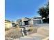 House exterior with a two-car garage and desert landscaping at 13622 W Peck Ct, Litchfield Park, AZ 85340