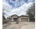 Charming single-story home featuring desert landscaping, neutral paint, and a two-car garage at 13622 W Peck Ct, Litchfield Park, AZ 85340