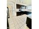 Kitchen boasts dark wood cabinets, white countertops, and stainless appliances at 13622 W Peck Ct, Litchfield Park, AZ 85340