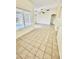 Bright living room with tile floors, high ceilings, and natural light from large windows at 13622 W Peck Ct, Litchfield Park, AZ 85340