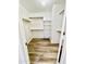 Large walk-in closet with wood-look floors and shelving at 13622 W Peck Ct, Litchfield Park, AZ 85340