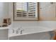 Clean bathroom with a bathtub and window shutters at 141 W Roadrunner Dr, Chandler, AZ 85286