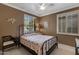 Cozy bedroom with a floral bedspread and plenty of natural light at 141 W Roadrunner Dr, Chandler, AZ 85286