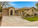 Tan two-car garage home with lush green landscaping at 141 W Roadrunner Dr, Chandler, AZ 85286