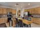 Kitchen boasts light wood cabinets, granite counters, and an island with seating at 141 W Roadrunner Dr, Chandler, AZ 85286