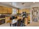 Kitchen boasts light wood cabinets, granite counters, and an island with seating at 141 W Roadrunner Dr, Chandler, AZ 85286