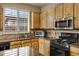 Kitchen features light wood cabinets, granite countertops, and stainless steel appliances at 141 W Roadrunner Dr, Chandler, AZ 85286