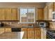 Kitchen features light wood cabinets, granite countertops, and stainless steel appliances at 141 W Roadrunner Dr, Chandler, AZ 85286