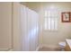 Clean bathroom with shower/tub combo, window with shutters, and wood-look flooring at 14202 N Buttercup Dr, Sun City, AZ 85351