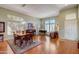 Elegant dining room with hardwood floors, a piano, and ample natural light at 14205 W Via Montoya Dr, Sun City West, AZ 85375