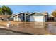 Single-story home with gray exterior, attached garage, and mature landscaping at 1510 E Edgewood Ave, Mesa, AZ 85204