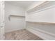 Large walk-in closet with shelves and hanging rods at 16744 W Cavedale Dr, Surprise, AZ 85387