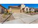 Single-story home with a red door and landscaped front yard at 16744 W Cavedale Dr, Surprise, AZ 85387